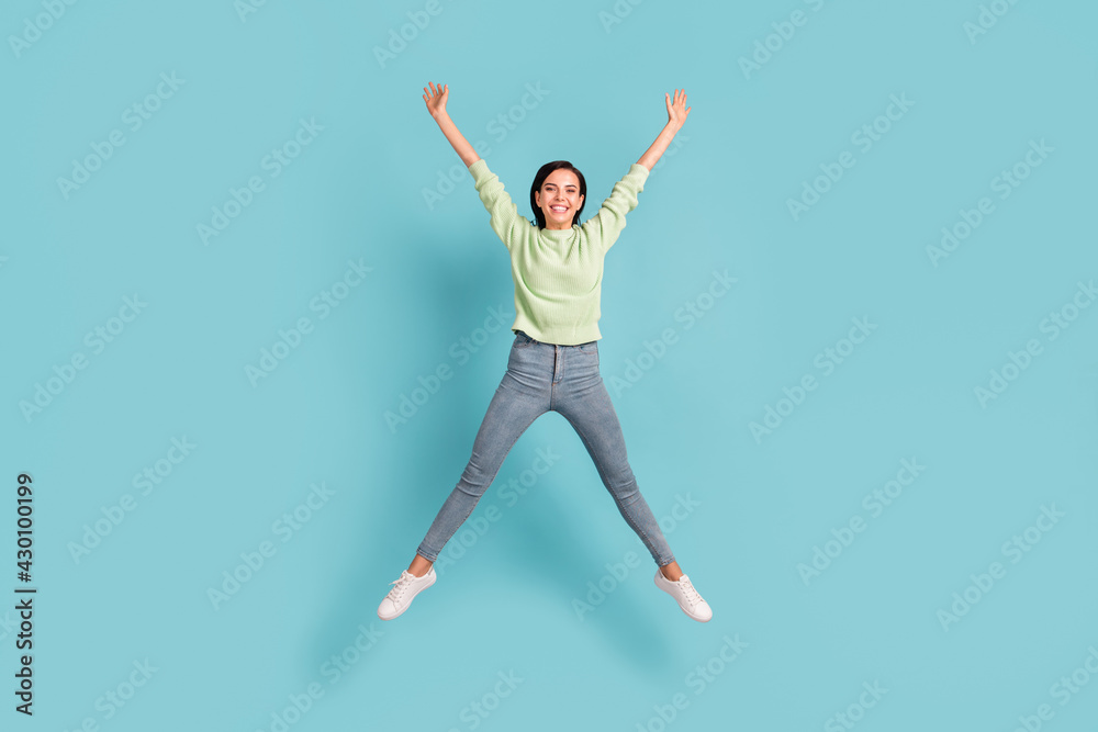 Full length body size view of pretty carefree glad cheerful girl jumping having fun isolated over bright blue color background