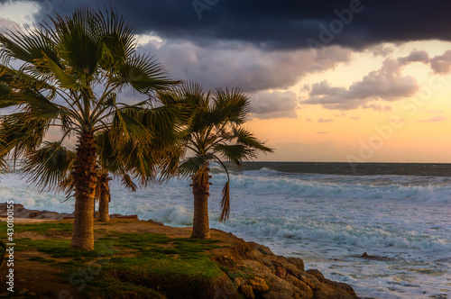 Cloudy sunset in the stormy sea on a tropical island.