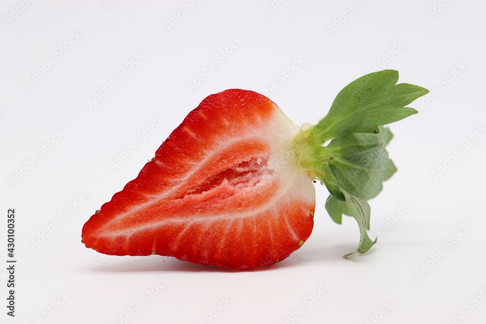 sliced strawberry with leaf on white background sliced strawberry with leaf on white background