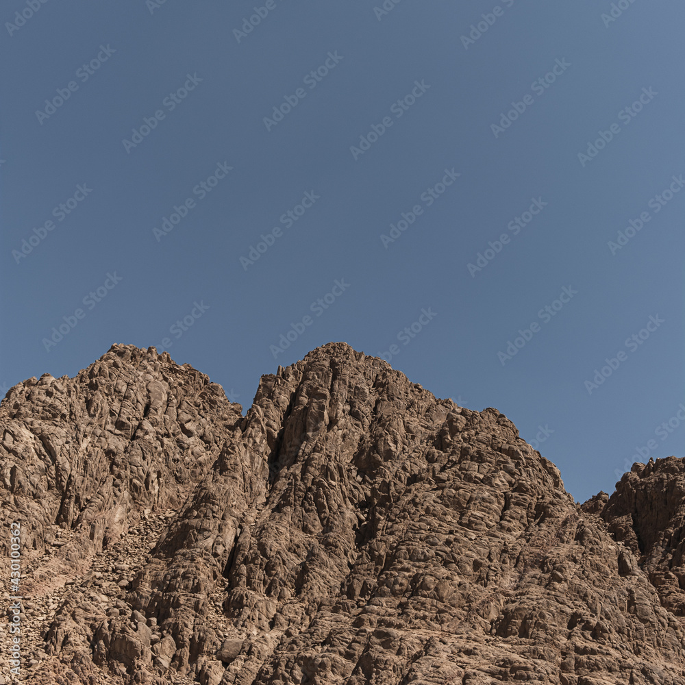 Picturesque view on sandstone mountain in desert with blue sky. Landscape with top of the high hill