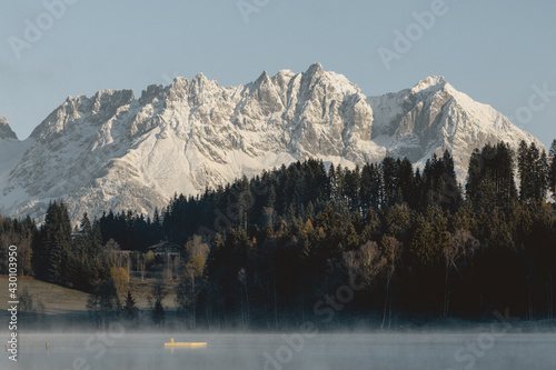Snowy mountain range in background of a lake