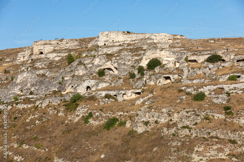 View of Gravina river canyon and park of the Rupestrian Churches of Matera with houses in caves di Murgia Timone near ancient town Matera (Sassi), , Basilicata,  Italy