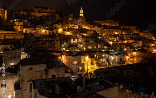 Obraz na plátně Amazing lighted buildings in ancient Sassi district by night in Matera, well-known for their ancient cave dwellings