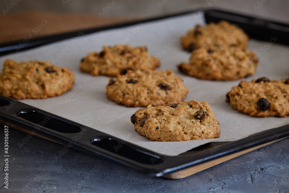 Oatmeal cookies from the oven on the grid on the gray table Oatmeal cookies from the oven on the grid on the gray table