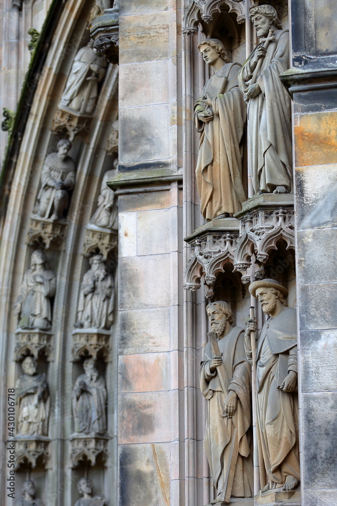 Close-up on statues and ornaments (Dutch Gothic architecture) on the external facade of St Janskathedraal (St John's Cathedral), located in the historical center of Hertogenbosch, Netherlands Close-up on statues and ornaments (Dutch Gothic architecture) on the external facade of St Janskathedraal (St John's Cathedral), located in the historical center of Hertogenbosch, Netherlands