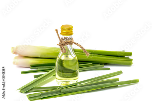 lemongrass oil In a transparent bottle,  fresh lemongrass placed separately isolated on white background