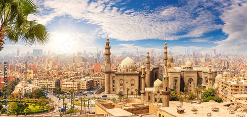 Famous Mosque of Sultan Hassan behind the palm tree, Cairo skyline, Egypt