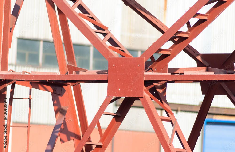 Detail of the underside of a red suspension bridge
