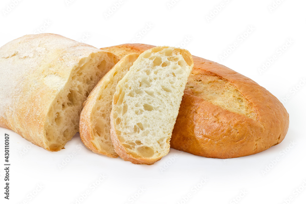 Partly sliced ciabatta against wheat bread on white background Partly sliced ciabatta against wheat bread on white background