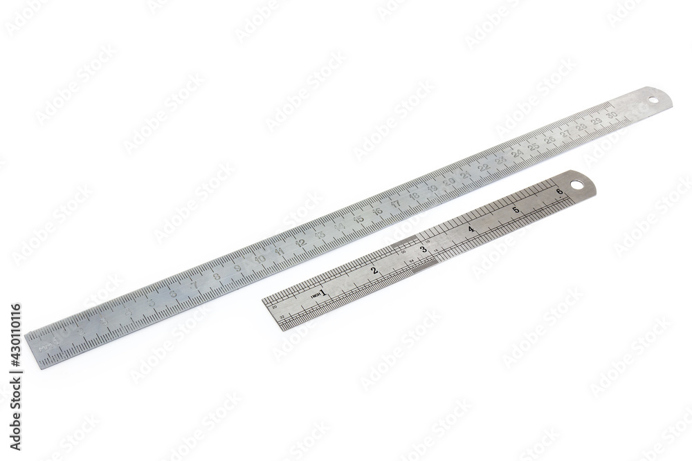 Two metal measuring rulers in millimeters and inches Two metal measuring rulers in millimeters and inches