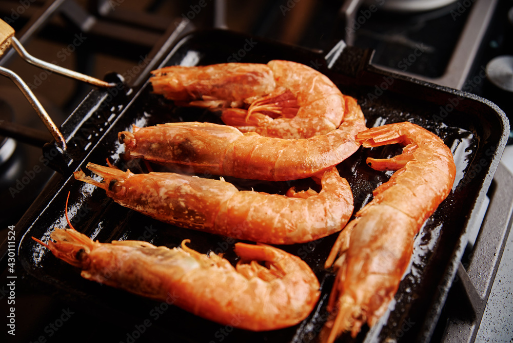 Grilled large shrimps with lemon and spices on the grill pan Grilled large shrimps with lemon and spices on the grill pan