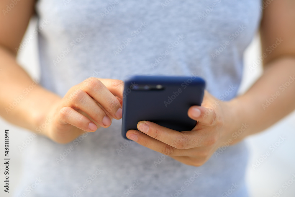 Asian woman using smartphone outdoors Asian woman using smartphone outdoors