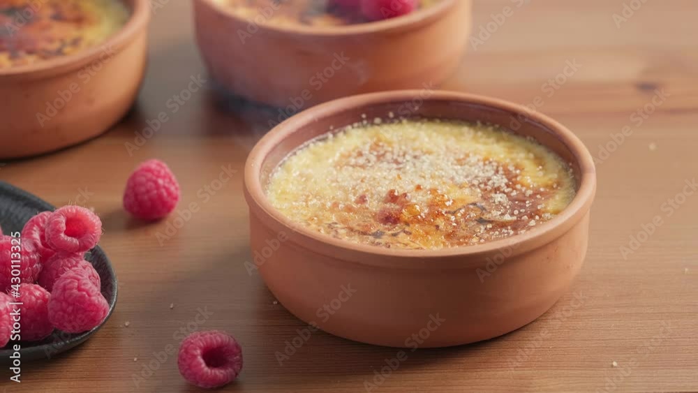Caramelizing sugar on top of crème brulee dessert with a gas burner Close-up selective focus. Making a delicious dessert with cream Caramelizing sugar on top of crème brulee dessert with a gas burner Close-up selective focus. Making a delicious dessert with cream