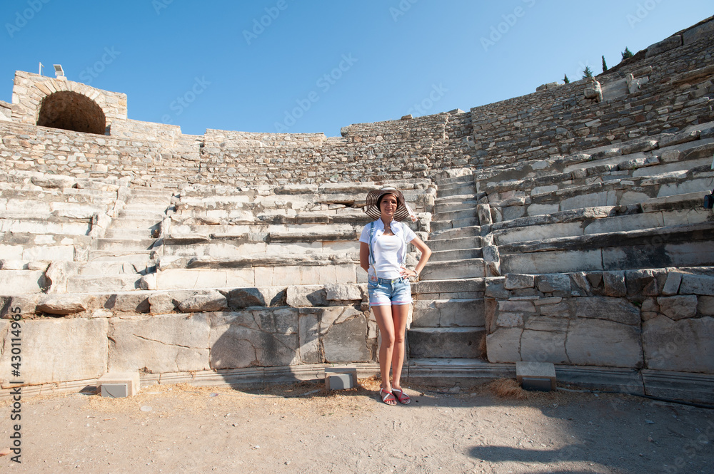 Girl tourist on the background of ancient buildings