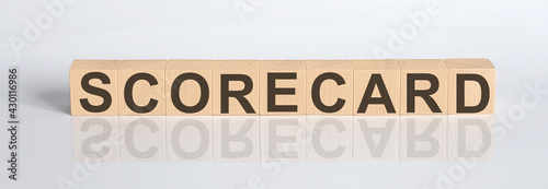SCORECARD word from wooden blocks on the white desk