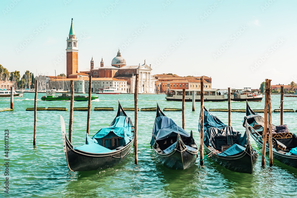 historic center of Venice is waiting for tourists against the backdrop of gondolas. Sea view from Piazza San Marco in Venice, with the bell tower of St. Mark in the background.