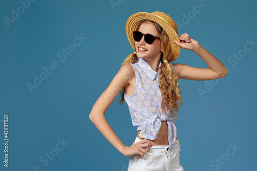 beautiful little girl in summer hat and sunglasses