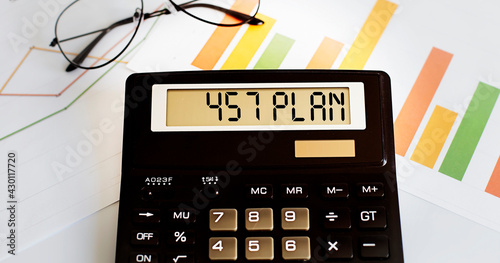 calculator with the word 457 PLAN on display with chart and glasses photo