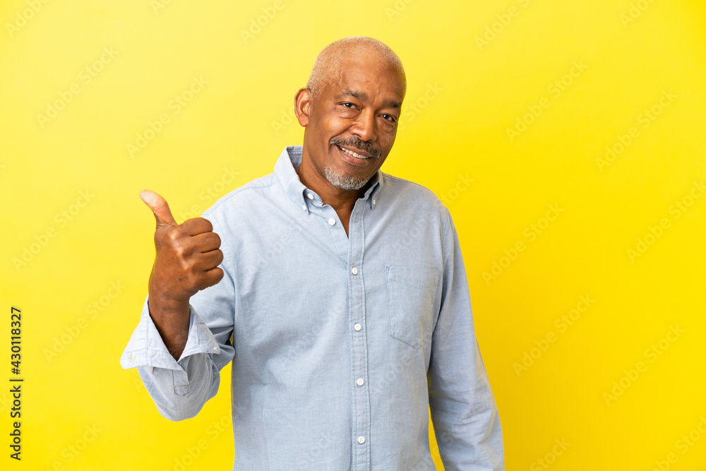 Cuban Senior isolated on yellow background pointing to the side to present a product Cuban Senior isolated on yellow background pointing to the side to present a product