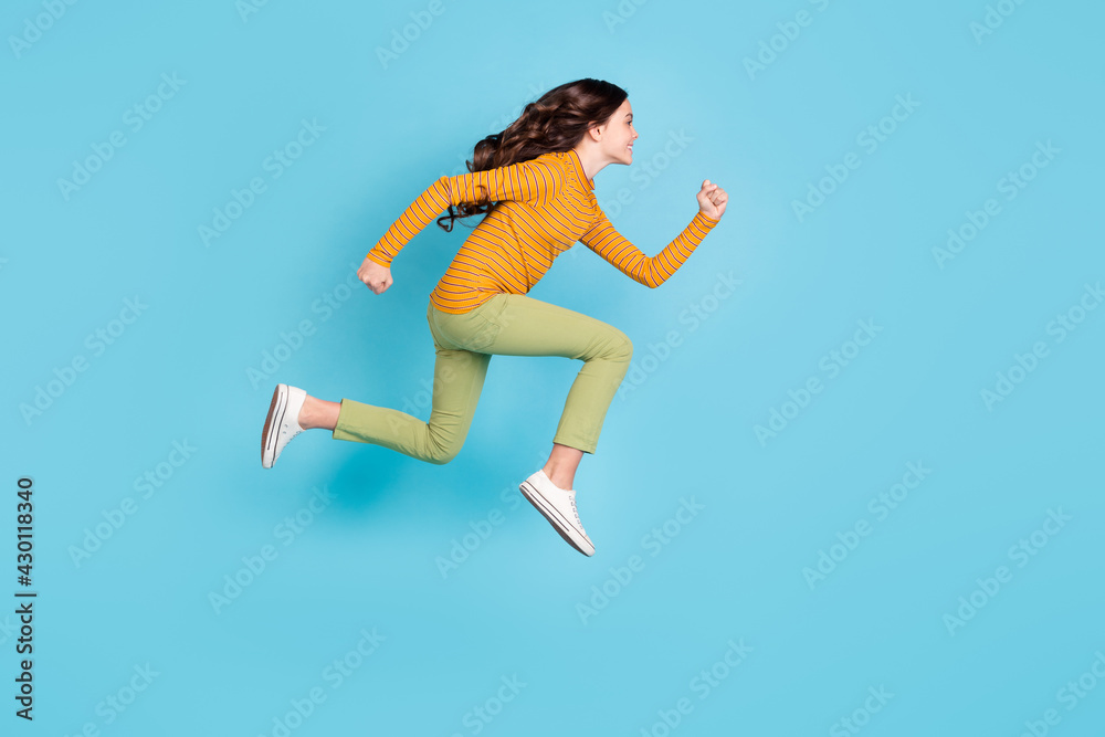 Full body profile portrait of carefree pupil hurry fast look empty space toothy smile isolated on blue color background