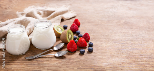 glass jars of yogurt with fresh berries