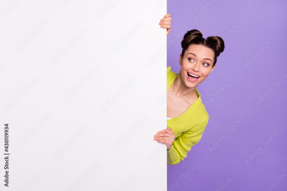 Photo portrait of young woman curious looking at blank space smiling interested isolated pastel purple color background Photo portrait of young woman curious looking at blank space smiling interested isolated pastel purple color background