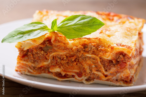 plate of lasagna with green basil
