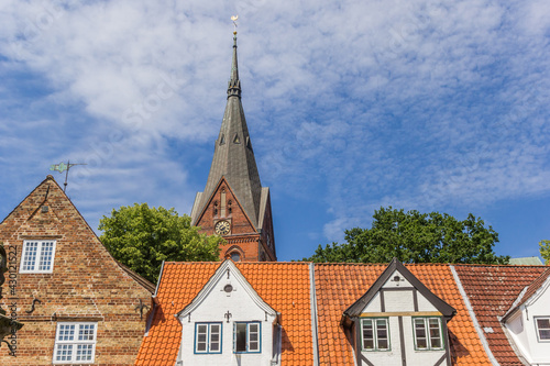 Church tower over roofs of old houses in Flensburg, Germany