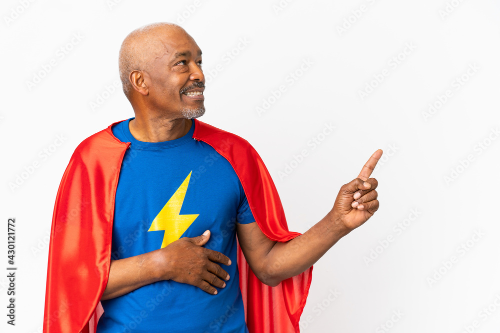 Super Hero senior man isolated on white background pointing finger to the side and presenting a product Super Hero senior man isolated on white background pointing finger to the side and presenting a product