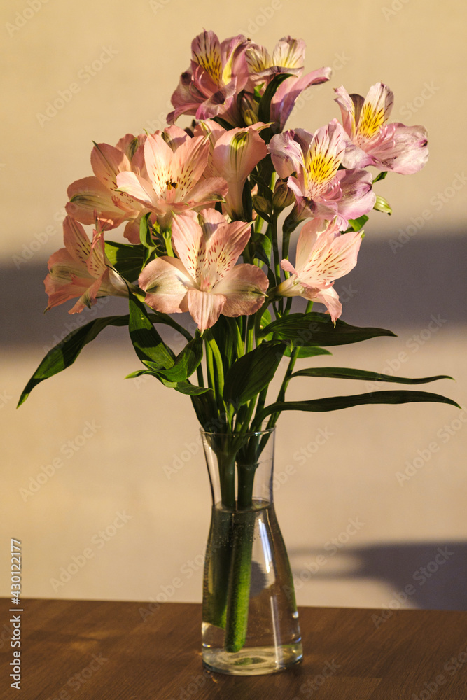 A bouquet of flowers from Alstroemeria in a glass vase A bouquet of flowers from Alstroemeria in a glass vase