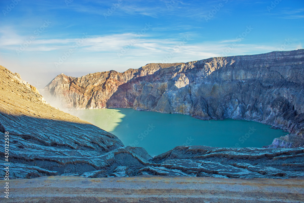 Naklejka premium Aerial view of Kawah Ijen acid lake and sulfur mines from the top of volcano. The Ijen volcano complex is a group of composite volcanoes in the Banyuwangi Regency of East Java, Indonesia.