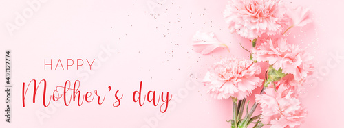 Banner with pink carnations on pink background with Happy Mother's day greeting.