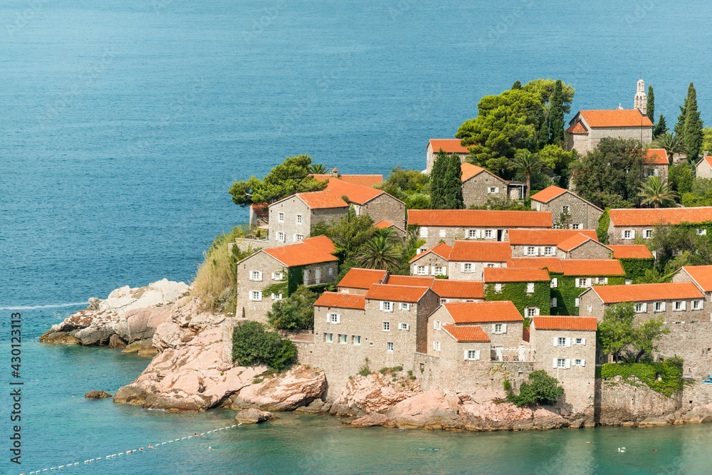 Red tiled roofs of famous Sveti Stefan island on Adriatic coast, Montenegro