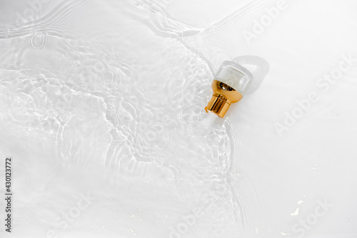 Transparent golden bottle with pipette and hylauronic acid. Top horizontal view copyspace