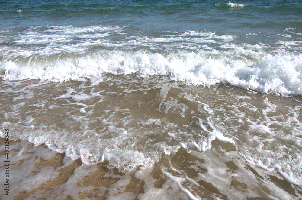 Tide coming in along the beach.