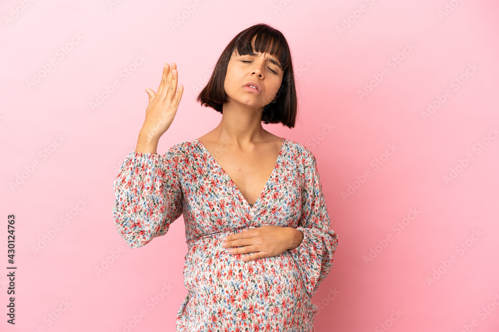 Young pregnant woman over isolated pink background with tired and sick expression Young pregnant woman over isolated pink background with tired and sick expression