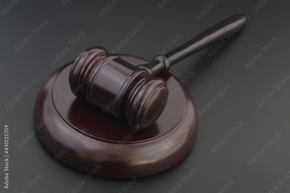 Wooden judge gavel on black table close up, legal and law concept. Wooden judge gavel on black table close up, legal and law concept.