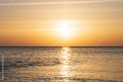 Silhouette of sea kayak during sunrise