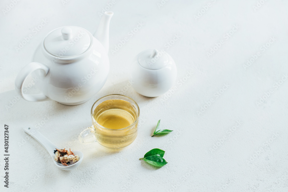 .tea service with tea in a transparent cup on a white background with free space .tea service with tea in a transparent cup on a white background with free space