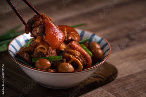 Photography Eating Taiwanese food pork knuckle in a bowl with chopsticks