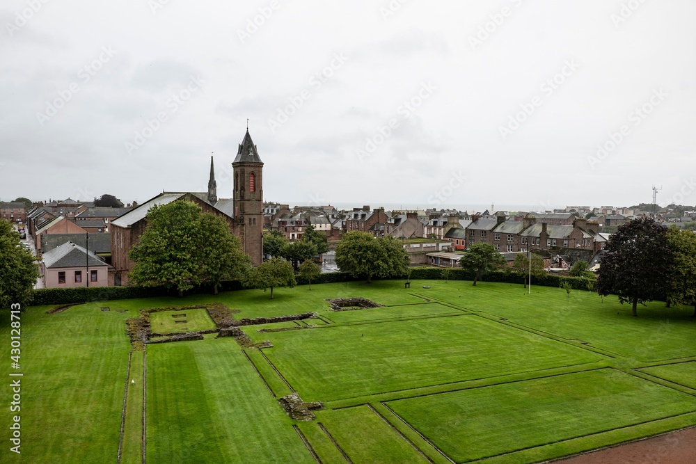 Courtyard of the Arbroath Abbey in Scotland with cityscape of the town