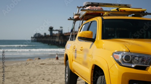Yellow lifeguard car  Oceanside beach  California USA. Coastline rescue life guard pick up truck  lifesavers vehicle. Iconic auto and ocean coast. Los Angeles vibes  summertime aesthetic atmosphere.