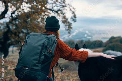 woman hiker next to dog nature mountains friendship travel
