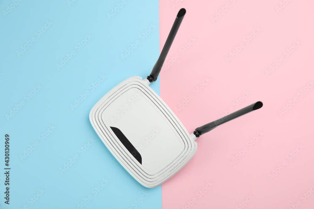 Modern Wi-Fi router on color background, top view Modern Wi-Fi router on color background, top view