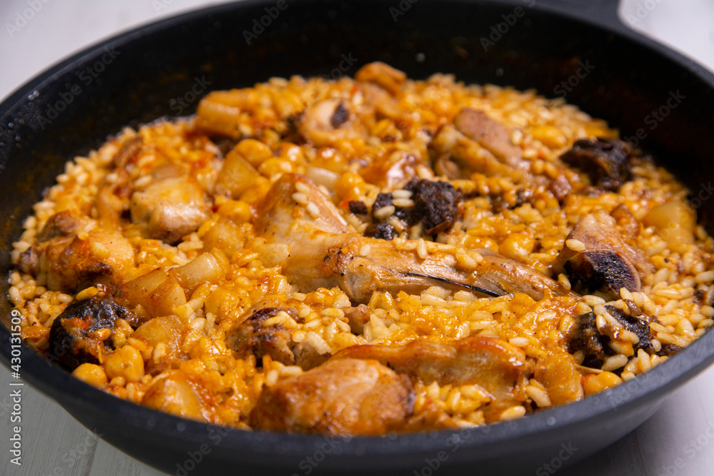 Montaña rice with wild rabbit, blood sausage, pork rib and chickpeas. Traditional spanish rice and tapa. Montaña rice with wild rabbit, blood sausage, pork rib and chickpeas. Traditional spanish rice and tapa.