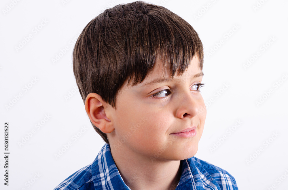 Cute boy in blue plaid shirt looking right side Cute boy in blue plaid shirt looking right side