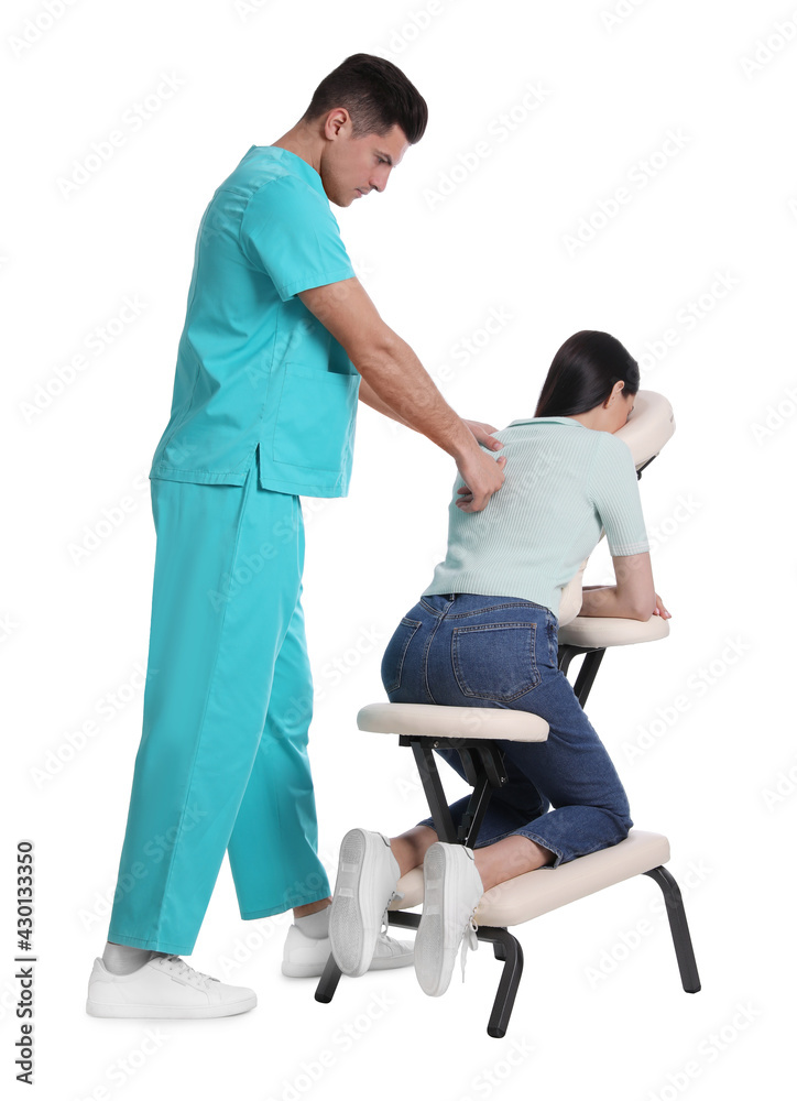 Woman receiving massage in modern chair on white background Woman receiving massage in modern chair on white background