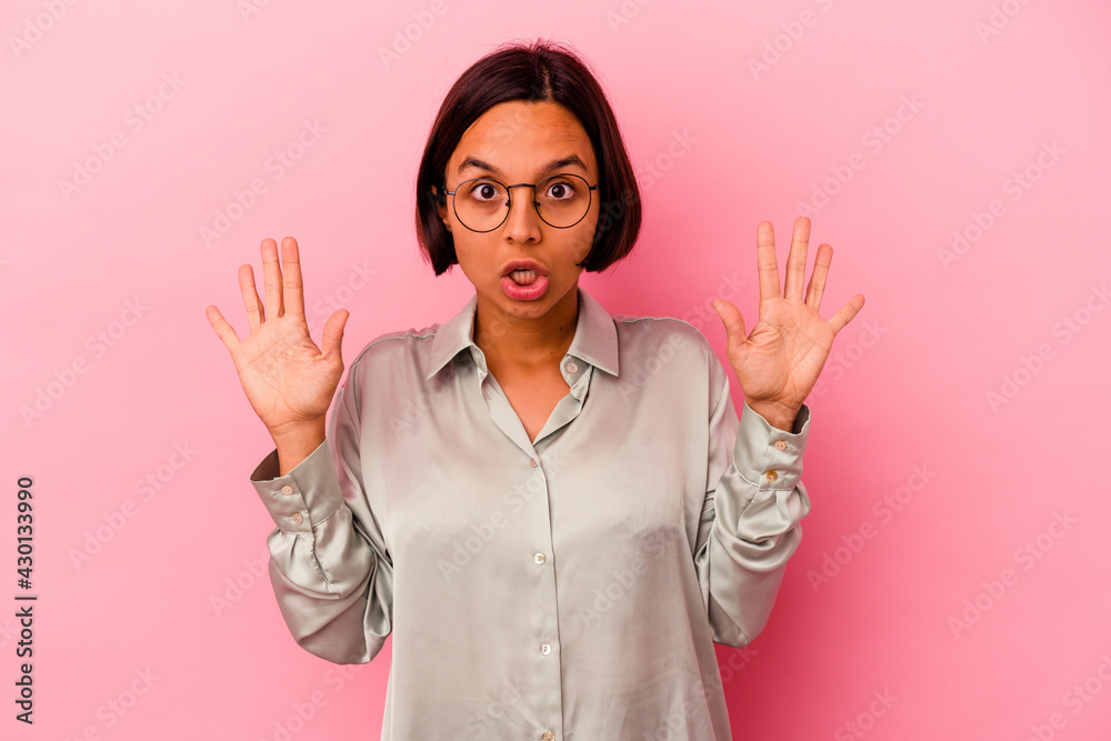 Young mixed race woman isolated on pink background having an idea, inspiration concept.
