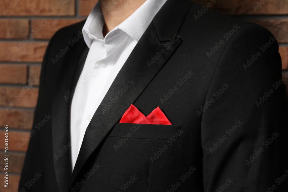 Man with handkerchief in breast pocket of his suit near brick wall, closeup - obrazy, fototapety, plakaty 