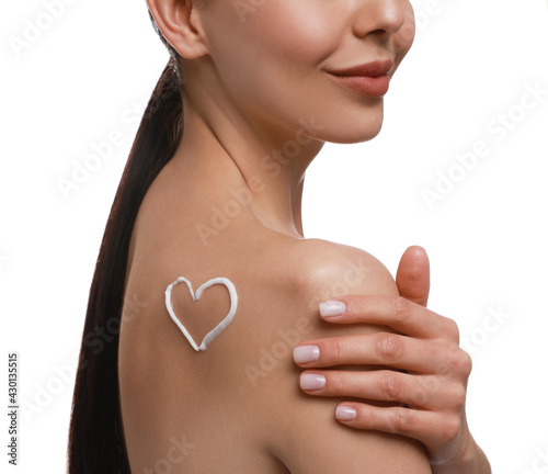 Young woman applying body cream onto her back against white background, closeup